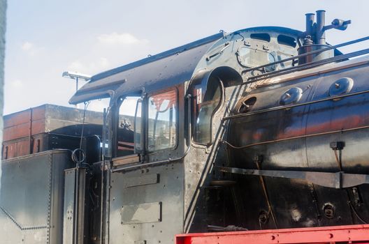 Detail view of the train window of an old steam locomotive.