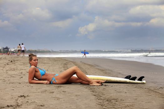 Surfer girl resting on the ocean, Bali. Indonesia