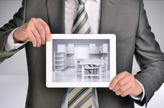 Three-dimensional model of kitchen in tablet screen. Man holding tablet in hand. Gray background