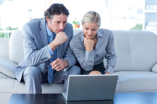 Business people using laptop in the office