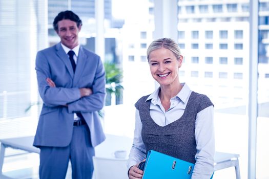 Business people smiling at the camera in the office