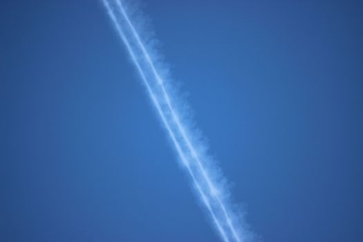 Trace of an airplane in the blue sky