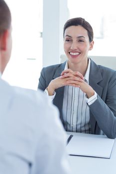 Businesswoman conducting an interview with businessman in an office
