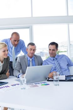 Business team working together on laptop in the office