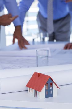 team of business people looking at construction plan in office