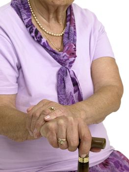 Hands of an old woman with a cane