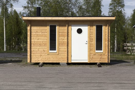 A little cabin in timber with door and windows