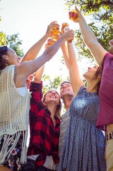 Happy friends in the park having beers on a sunny day