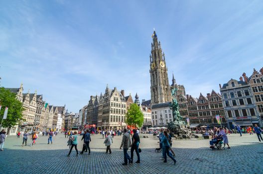 Antwerp, Belgium - May 10, 2015: Tourist visit The Grand Place with the Statue of Brabo, throwing the giant's hand into the Scheldt River and the Cathedral of our Lady. on May 10, 2015 in Antwerp, Belgium. 