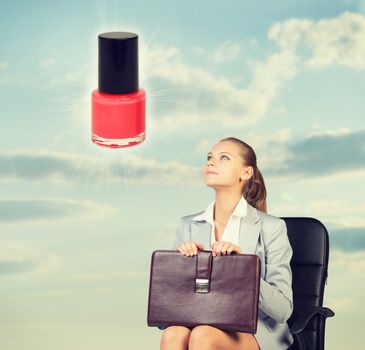 Business woman in skirt, blouse and jacket, sitting on chair imagines nail polish. Against background of sky and clouds