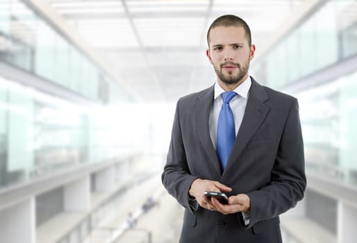 young business man looking to his phone, at the office