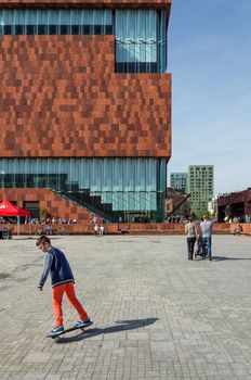 Antwerp, Belgium - May 10, 2015: People visit Museum aan de Stroom (MAS) along the river Scheldt in the Eilandje district of Antwerp, Belgium, on May 10, 2015. Opened in May 2011, is the largest museum in Antwerp.