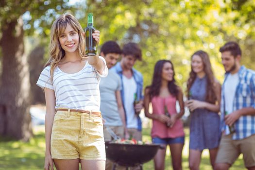 Happy friends in the park having barbecue on a sunny day