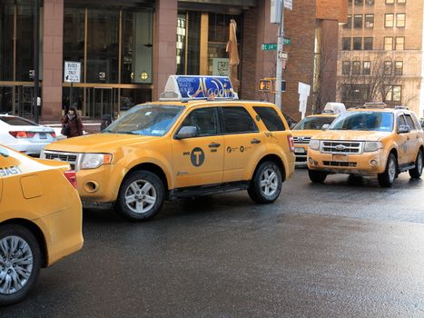 A line of Park Avenue taxicabs in Manhattan in winter.