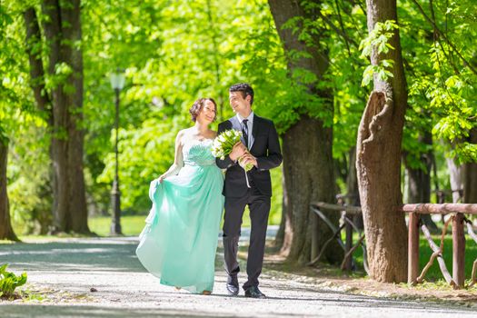 Bride and groom. Portrait of a loving wedding couple strolling in Tivoli park in Ljubljana, Slovenia.