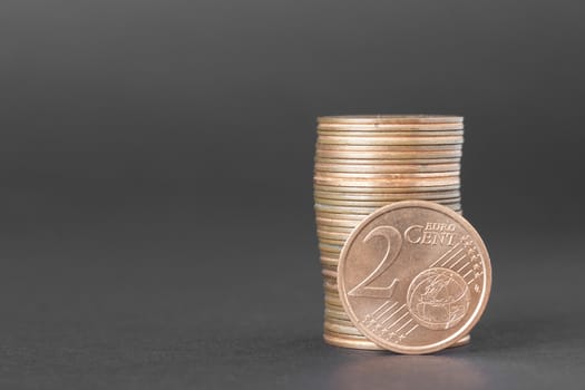 Two cents of euro isolated on a dark background to understand a business concept