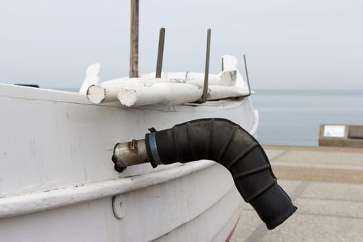 A boat laying ashore with the oars and the exhaust pipe in Normandy