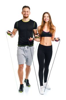 Happy athletic couple - man and woman with with ropes on the white background