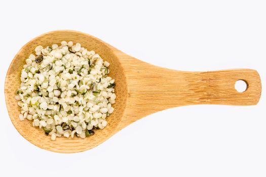 hemp seed hearts on a small wooden spoon isolated on white with a clipping path
