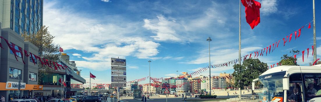 ISTANBUL, TURKEY - OCTOBER 23, 2014: People walking at Taksim Square in Istanbul. Taksim Square is a leisure district famous for its restaurants, shops, and hotels.