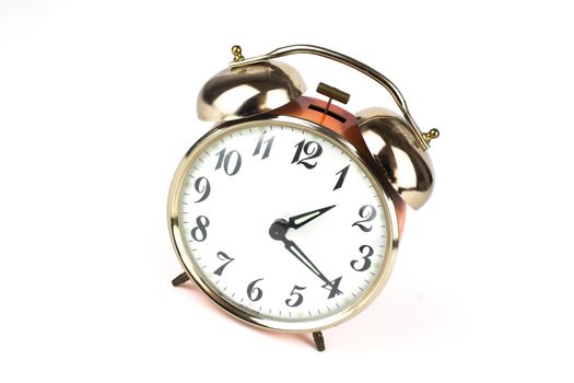 Close up of an alarm clock on a white background