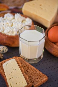 still life with dairy products as milk, cheese cottage cheese eggs and bread 