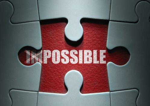 Uncovered missing piece from a jigsaw puzzle revealing the word possible with impossible crossed out
