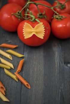 food background on rustic wood with pasta and tomatoes