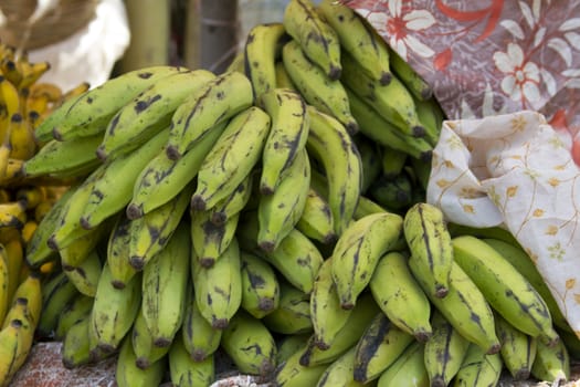 Fresh juicy bananas on a counter in the market of India of Goa.