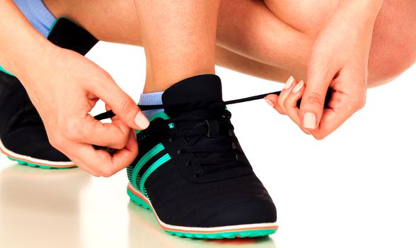 Running shoes being tied by woman, white background, isolated, copyspace
