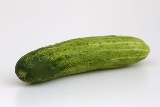 A fresh and tasty green vine ripened garden grown cucumber isolated on white.