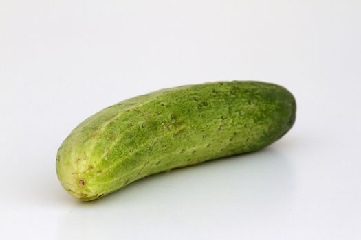 A fresh and tasty green vine ripened garden grown cucumber isolated on white.