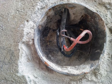 extreme closeup of exposed wires in wall socket, shallow focus 