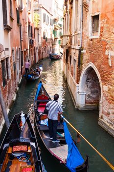 VENICE, ITALY - MAY 06: View of typical Gondolier in the Venice lagoon on May 06, 2015