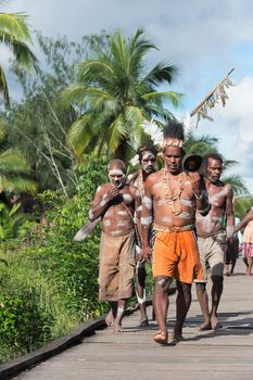 JOW VILLAGE, ASMAT, NEW GUINEA, INDONESIA -JUNE 28:The Village follows the ancestors embodied in spirit mask as they tour the village the Doroe ceremony. June28, 2012 in Jow Village, Asmat, Indonesia 