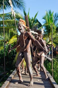 JOW VILLAGE, ASMAT, NEW GUINEA, INDONESIA -JUNE 28:The Village follows the ancestors embodied in spirit mask as they tour the village the Doroe ceremony. June28, 2012 in Jow Village, Asmat, Indonesia 