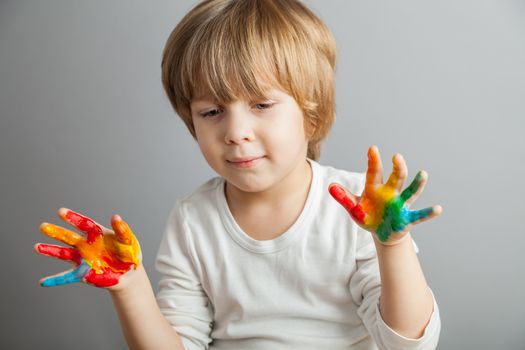 little girl and boy hands painted  in colorful paints