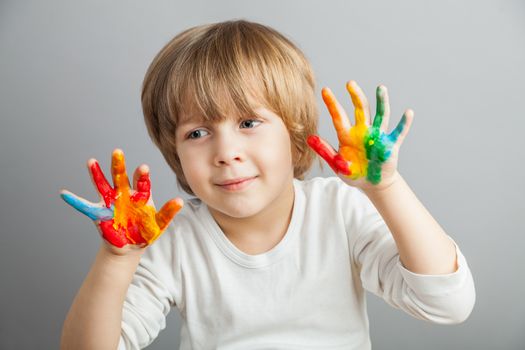 little girl and boy hands painted  in colorful paints