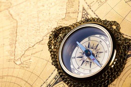 Compass on the old map background