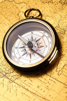Compass on the old map background