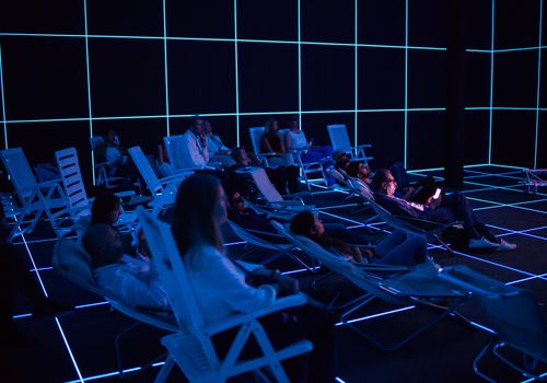 VENICE, ITALY - MAY 06: People looking "Factory of the Sun" video installation by Hito Steyerl at German pavilion during the 56th Venice Biennale on May 06, 2015