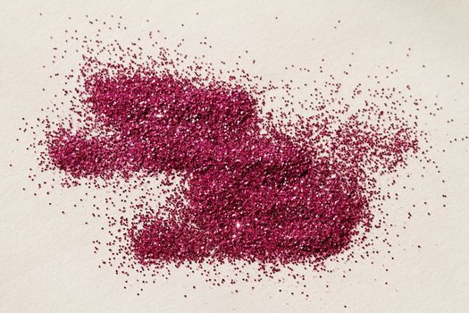 Magenta glitter on light background - macro photo