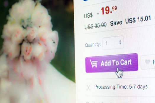 Mouse clicking add to cart button on flowers website while online shopping