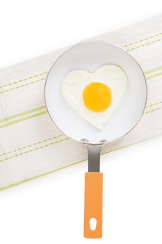 Fried egg in heart shape on pan isolated on white background, top view. Fresh modern image language. Culinary arts. 