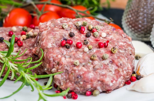 Raw Minced Hamburger Meat with Herb and Spice Prepared for Grilling