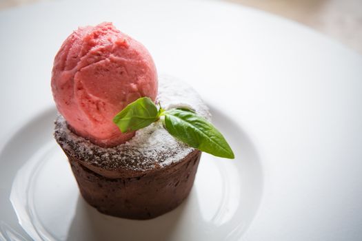 Warm dessert chocolate cake Fondant served on plate with ice-cream ball