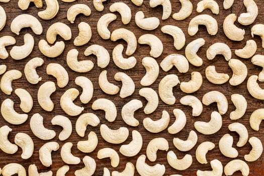 background texture of cashew nuts on a rustic grunge wood