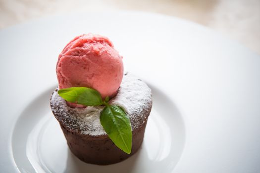 Warm dessert chocolate cake Fondant served on plate with ice-cream ball