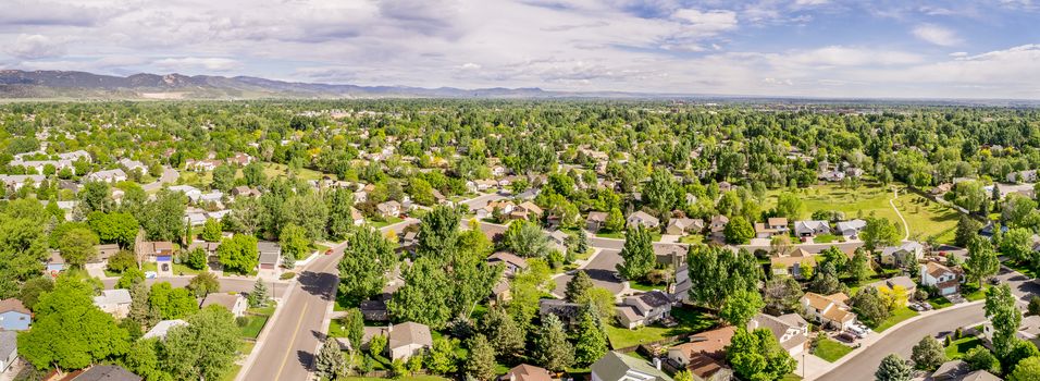aerial panorama of Fort Collins with downtown and Rocky Mountains in a distance, late spring scenery