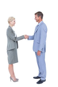 Smiling business people shaking hands against a white screen